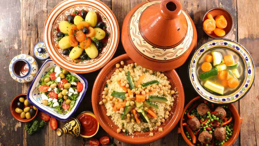 A colorful table filled with traditional Moroccan dishes tagines and couscous
